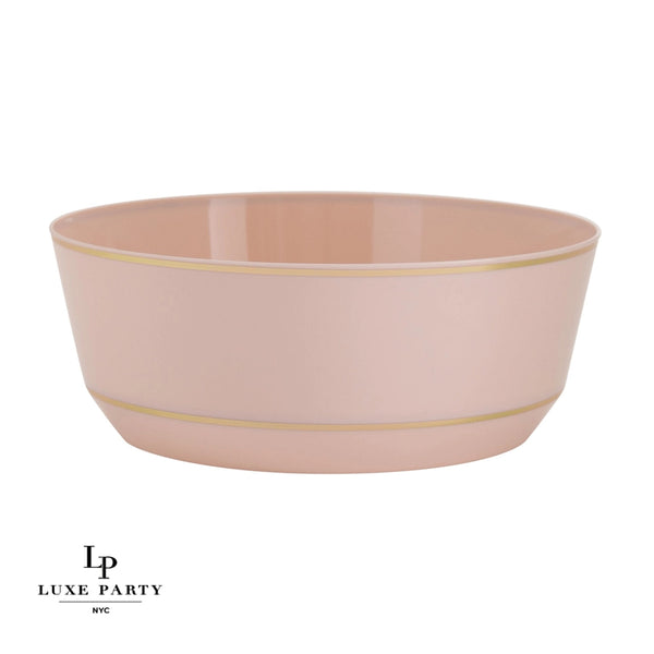 Blush pink ceramic bowl with delicate gold rim accents. Stylish and versatile dinnerware, ideal for serving soups, salads, or desserts.