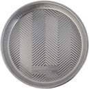 Nordic Ware 9-inch round aluminum cake pan with embossed grid texture.
