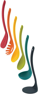 A complete, multicolored kitchen utensil set neatly stacked and stored on a black magnetic stand.