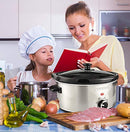 Stainless steel slow cooker with black lid and control dial.