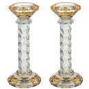 A pair of 6.3-inch gold-toned crystal candlesticks, each with a faceted, diamond-shaped base and top, and a clear twisted stem filled with decorative crushed rocks.