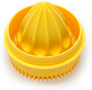 A yellow Jarware juicer lid attachment for a wide-mouth mason jar. It has a ridged reamer in the center and a strainer around the edge.