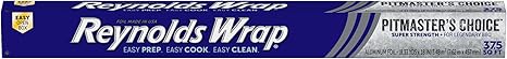 Roll of Reynolds Wrap Pitmaster’s Choice Extra Thick Aluminum Foil with packaging labeled 18-inch extra wide grill foil on a white background.