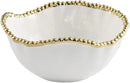 White porcelain salad bowl with gold beaded rim on a white background.