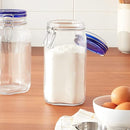 A clear glass Bormioli Rocco Fido jar with a dark blue hinged lid and wire bail closure.