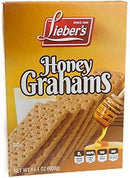 A stack of rectangular, light brown graham crackers with perforated lines and a sprinkling of brown specks on a white background.