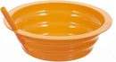 A colorful collapsible silicone bowl in orange with straw
