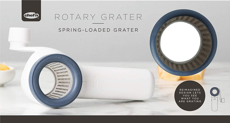 Chef'n spring-loaded rotary grater in white with blue accents, shown with a removable grating drum, designed for easy cheese grating.