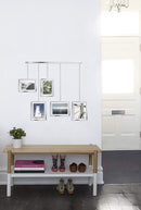 A modern silver photo display featuring five square frames hanging from a horizontal bar by thin rods.