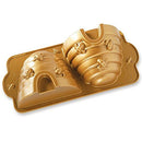 Toffee-colored Nordic Ware Beehive Cake Pan with two detailed beehive-shaped cavities, displayed on a white background.