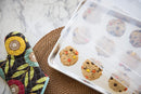 cookies on a tray, covered with the Clear Nordic Ware half sheet cover, on a marble countertop
