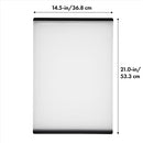 OXO Good Grips plastic carving and cutting board with drip-catcher groove and non-slip feet on a white background.