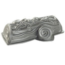 Silver Nordic Ware yule log-shaped baking pan with detailed textured design, shown on a white background.