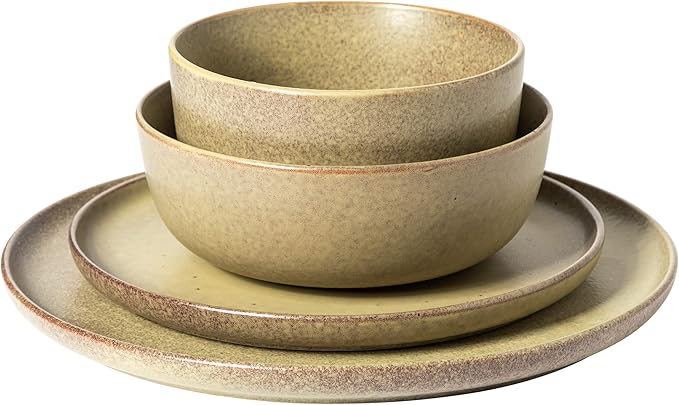 Cream-colored 16-piece stoneware dinnerware set with dinner plates, salad plates, soup bowls, and smaller bowls on a white background.