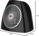 Black Vornado personal space heater with compact design and front grille on a white background.