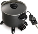 A black electric multi-cooker with a nonstick interior, short legs, a glass lid, and a detachable black temperature control probe.