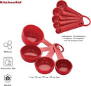 KitchenAid 9-piece red measuring cups and spoons set with soft grip handles.