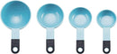 A set of nine light blue KitchenAid measuring cups and spoons with black soft-grip handles, spread out on a white surface. The set includes four cups and five spoons.