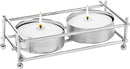 A set of two round tealight candles in metal cups, held within a small, rectangular, silver nickel-plated metal frame on four small feet.