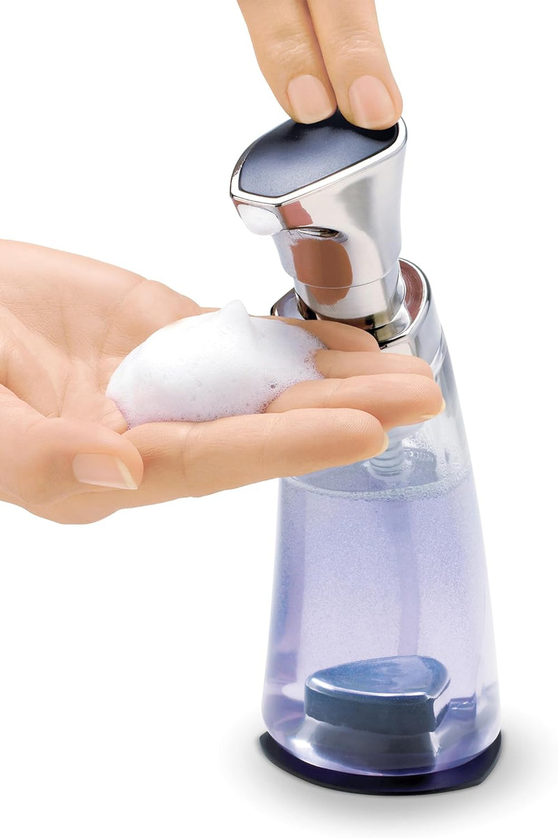 Clear plastic foaming soap dispenser with a silver pump and black suction base.