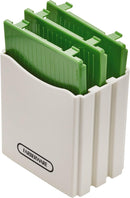 Green handheld Farberware mandoline slicer with stainless steel blade.