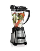 A Hamilton Beach blender with a brushed stainless steel and black base, a clear Tritan jar filled with fruits and ice, and a removable gray mesh strainer/chopper insert.