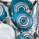 Farberware 15-Piece Aluminum Nonstick Cookware Set in a teal exterior with a light gray nonstick interior. The set includes various pots and pans with glass lids and black handles, along with a baking sheet and a set of black Prestige kitchen tools shown in an inset image.