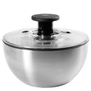 An OXO Good Grips Steel Salad Spinner with a sleek stainless steel bowl, a clear lid, and a black pump mechanism.