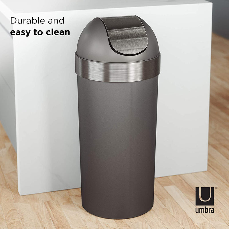Large grey trash can in kitchen next to cabinets