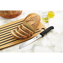 Victorinox serrated bread knife slicing through a crusty loaf of bread on a wooden cutting board.