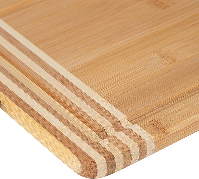 Medium rectangular bamboo cutting board with drip edge on a white background.