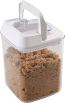 Kitchen Details 0.9L airtight food storage container made of clear plastic, allowing visibility of the brown sugar stored inside. The container features a white, easy-locking lid designed to keep contents fresh.