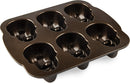 Nordic Ware bronze skull-shaped cakelet pan with six detailed cavities on a white background.