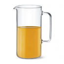 A clear Simax Agra 67-ounce glass pitcher filled halfway with orange juice, featuring a sturdy handle and a convenient pour spout.