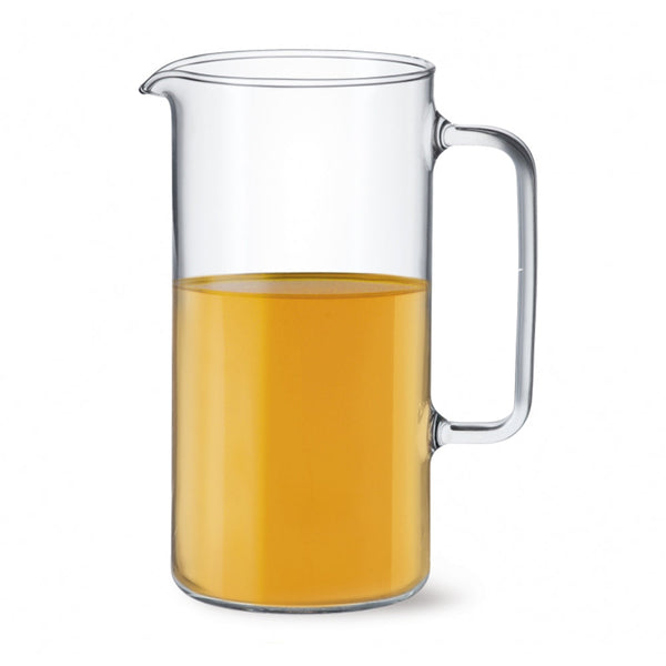 A clear Simax Agra 67-ounce glass pitcher filled halfway with orange juice, featuring a sturdy handle and a convenient pour spout.