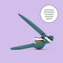 A side view of a teal-colored Chef'n FreshForce Lemon Squeezer, showcasing its ergonomic design with two long handles, and visible chrome-plated metal components at the hinge and pressing mechanism.