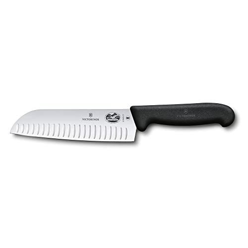A Victorinox 7-inch Fibrox Pro Santoku knife with a Granton edge, featuring a black ergonomic handle and a wide stainless steel blade.