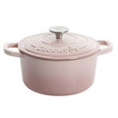 Blush pink cast iron Dutch oven with lid.
