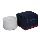 Trapp No. 24 Wild Currant 3.75 oz. Small Poured Candle in a frosted white glass container, placed next to its navy and red packaging.