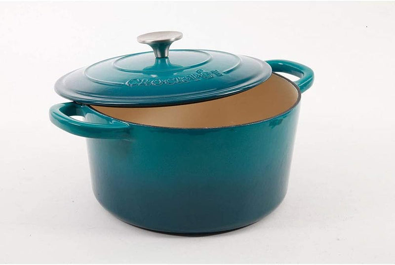 Partially open Dutch oven showing tan enameled interior