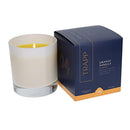 Trapp No. 4 Orange Vanilla 7 oz. Signature Candle in a frosted white glass container, placed next to its navy and orange packaging.