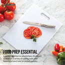 White Farberware cutting board with sliced tomatoes and a knife, showing smooth and durable surface.
