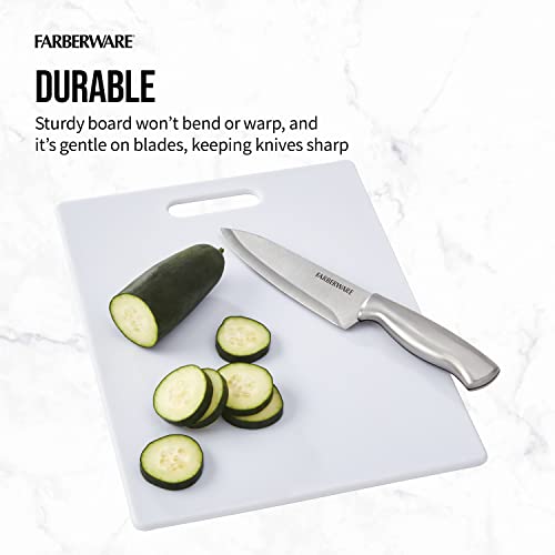 Durable Farberware cutting board with zucchini being sliced using a stainless steel knife.