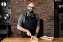 Andrew Rea (Babish) using the Clef knife while preparing food in a professional-style kitchen