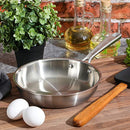 Babish stainless steel 8-inch frying pan styled with eggs, oil bottle, and wooden utensils