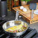 Babish 8-inch stainless steel fry pan cooking vegetables on stovetop