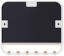 A sleek white wall-mounted organizer mirror with rounded corners, featuring a light wood shelf beneath it. Below the shelf, a white bar extends with several wooden peg hooks.
