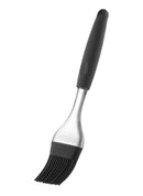 A black silicone pastry brush with a black handle, a clear plastic neck, and flexible black silicone bristles.