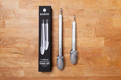 Babish stainless steel tong set displayed on a wooden surface next to the product box