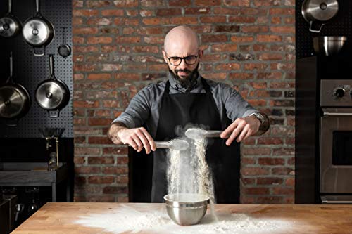 Chef using Babish stainless steel tongs to sift flour dramatically in a brick-walled kitchen